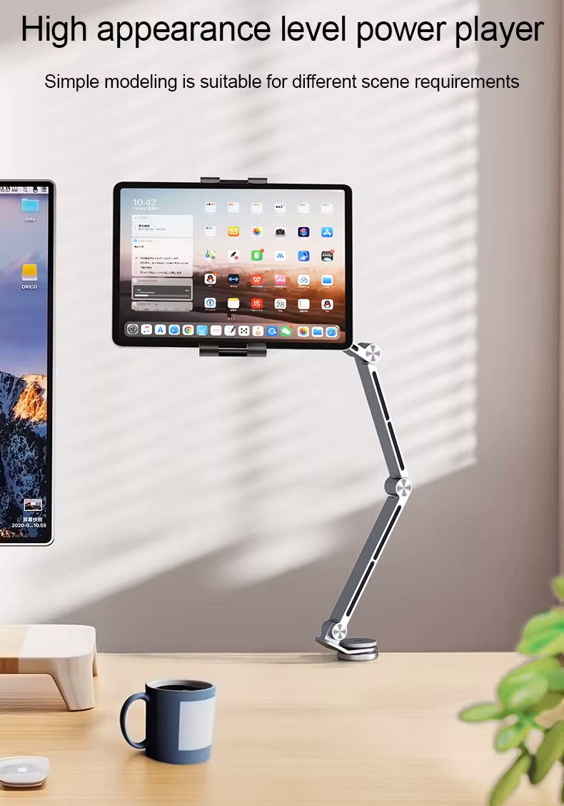 Aluminum alloy tablet holder with adjustable arm clamped to a desk, holding an iPad in a home office setting.